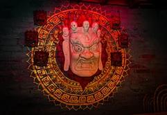 Traditional Nepali mask artwork on the restaurant wall